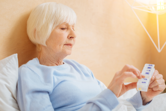 Woman taking pills before going to bed